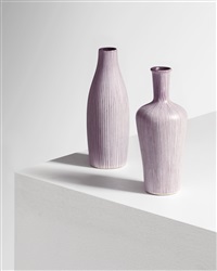 A set of two brown and white vases, designed by...
