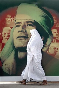 A Woman Passes a Giant Poster of ex-Libyan..., 2009 A Woman Passes a Giant Poster of ex-Libyan..., 2009