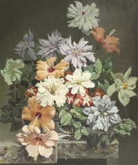 A still life of flowers in a glass vase on a ledge A still life of flowers in a glass vase on a ledge