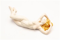 A PORCELAIN RECLINING NUDE FIGURE, 1950