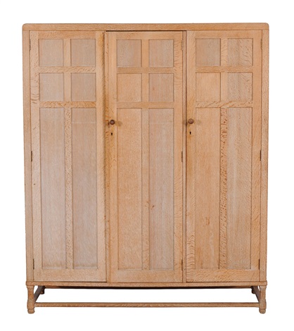 An Arts And Crafts Limed Oak Cotswold Triple Wardrobe By Heal And