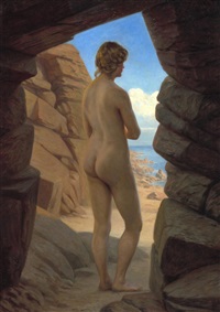 A female nude standing in a cave at the beach