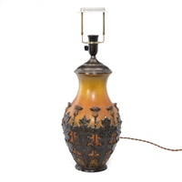 A large terracotta table lamp cast with relief...