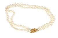 A two stranded pearl necklace set with numerous...