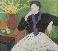 Seated woman dressed in a black blouse and a...