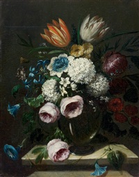 Still life of flowers in a glass vase on a stone