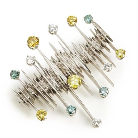 A diamond brooch set with numerous brilliant-cut white, yellow and ...