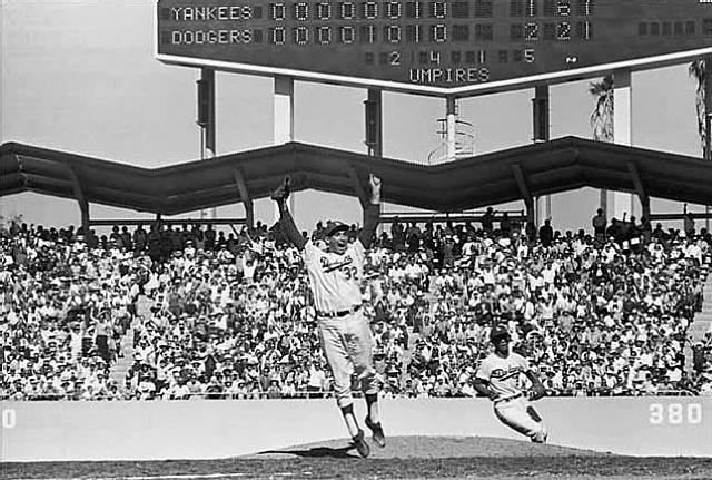 1963 world series final game - sandy koufax (jumping/celebrating), maury wills, dodger stadium, los angeles, ca by neil leifer